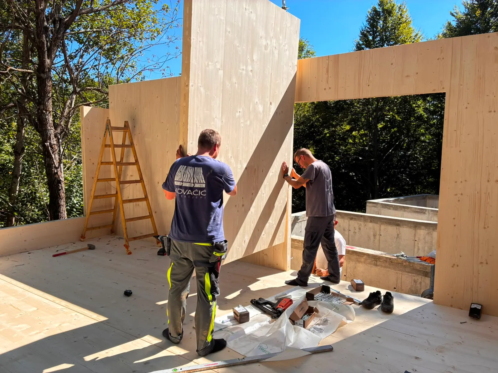 Builders assembling cross-laminated timber panels